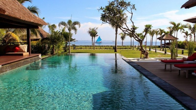 Infinity pool overlooking spacious garden area and sea view